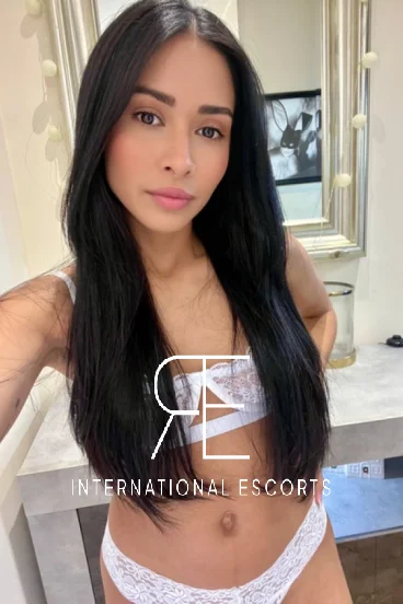 Clemmie in white lingerie, stylish Brazilian escort for travel or London stays