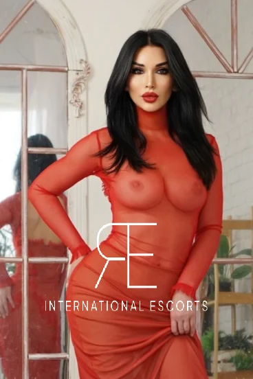 Refined Russian Rosaline in bold red lace gown, international beauty