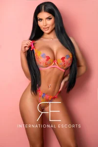 A profile picture of a busty brunette London escort named Haifa 
