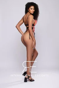 Gigi, ebony beauty in black and red lingerie looking back